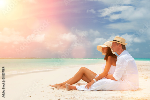 Happy honeymoon vacation at summer. Couple relax on the white sand of beach. Happy sea lifestyle. Young family, man and woman rest on the beach of ocean. Couple in love travel to island. Love travel © Dmytro Sunagatov