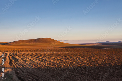 Agricultural landscape panorama with mountains n the background