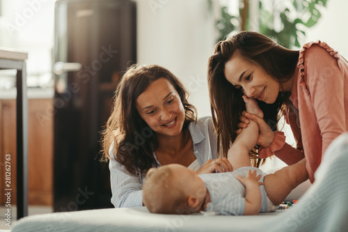 Affectionate women enjoying in time with a baby son at home. photo
