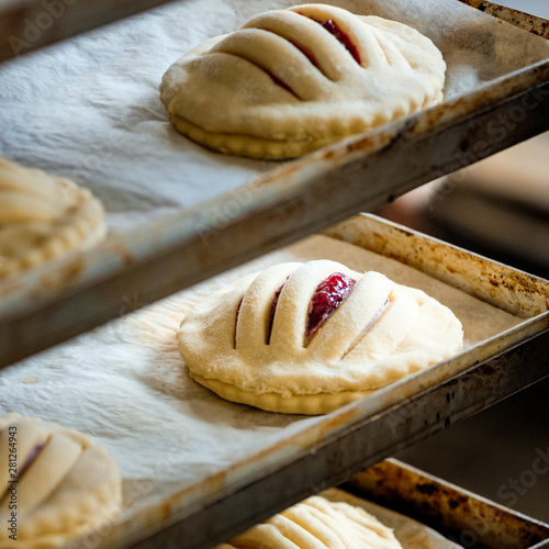 Finished production cookie in factory in the steel table. Production of biscuits, closeup. Working process. Private bakery. Production of bread.
