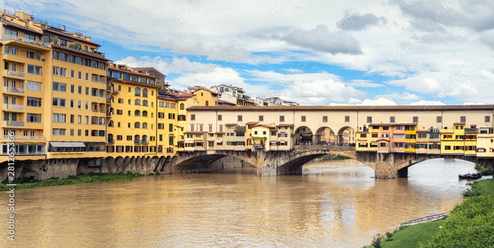Ponte Vecchio, Florence, Itlay, in day time, colorful houses and blue sky