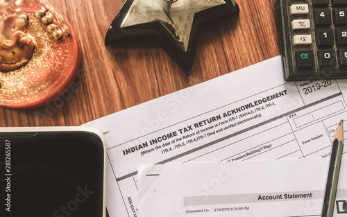 Close up of Indian Income tax return form ITR-2 return form is on the table next to a pen, calculator and a home mortgage loan application form placed on the desk. Financial Business concept.