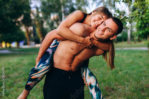 Couple man and woman have a fun time in the park outdoor