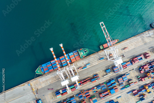 Aerial view. Container ship in pier with crane bridge carries out export and import business in the open sea. Logistics and transportation