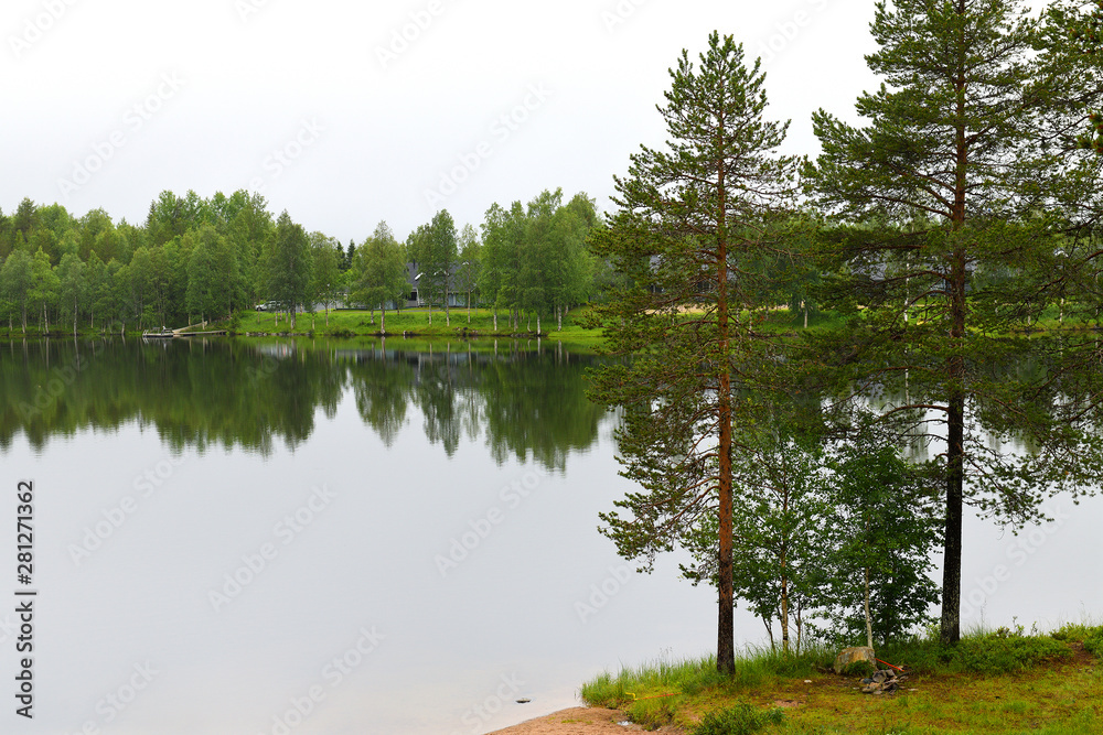Northern landscape with forest lake in rainy weather. Ruka, Finland Northern landscape with forest lake in rainy weather. Ruka, Finland
