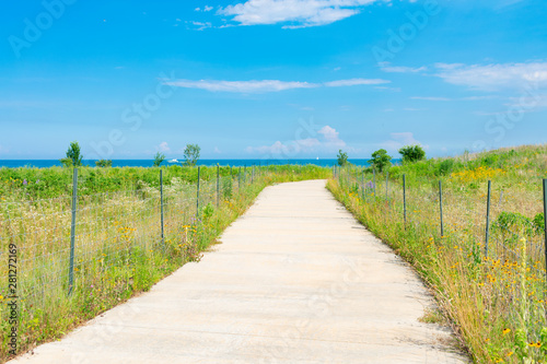 Path with Native Plants and a Blue Sky at Northerly Island in Chicago during the Summer by Lake Michigan © James