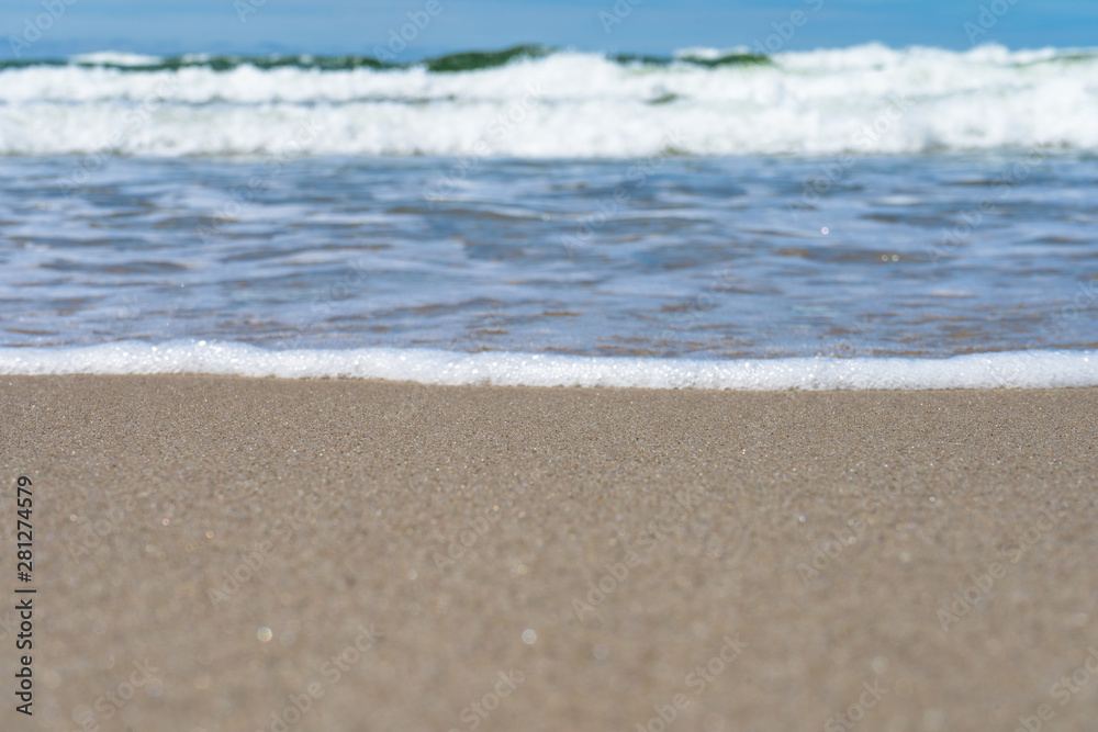 Seaside. A wave is coming. Small grains of sand close up. Concept. Background. Summer is over. Summer sales. Free space for text. Seaside. A wave is coming. Small grains of sand close up. Concept. Background. Summer is over. Summer sales. Free space for text.