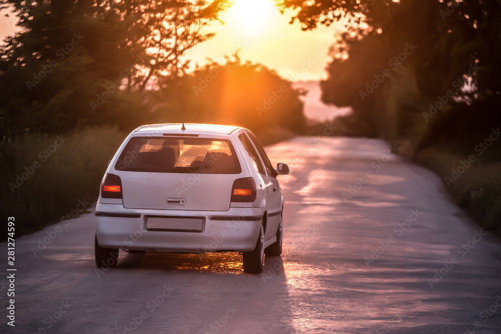 Fototapeta premium car moves on a highway at sunset