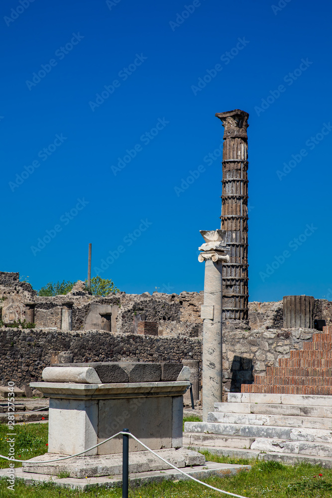 Ruins of the ancient Temple of Apollo with bronze Apollo statue in Pompeii