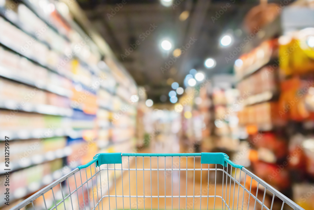 Shopping cart view with supermarket aisle shelves interior abstract blur defocused background