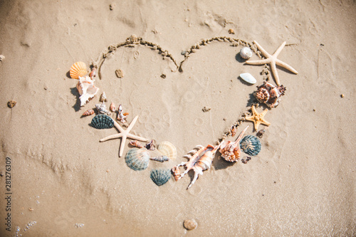 view of drawn love heart symbol on sand beach photo