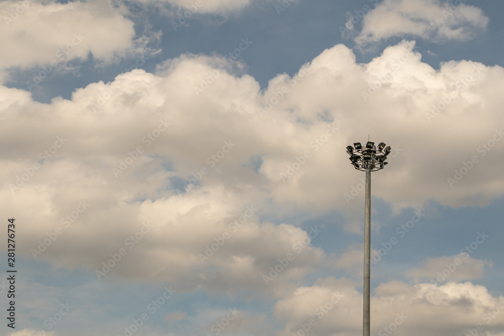 Electricity post with cloud and blue sky.