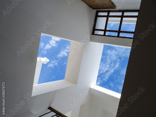 Architecture composition abstract building with white walls and winows. Blue sky and geometric forms. photo