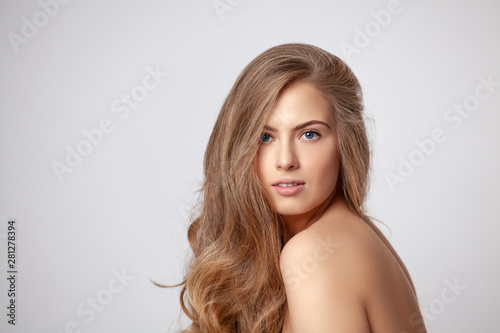 Beautiful woman portrait with long blonde hair.Spa girl is a model with perfect fresh skin. Blonde woman looking at the camera.