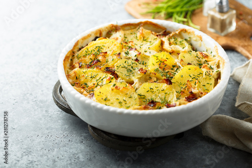 Homemade potato gratin with bacon and herbs