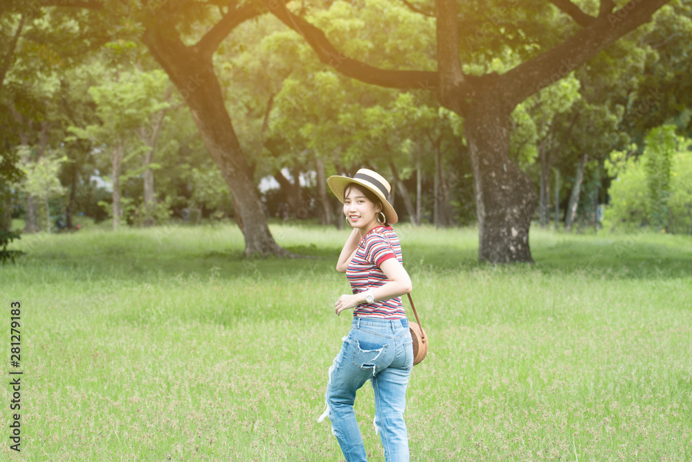 Young and cute Asian woman is enjoy lifestyle and travel into the Lumphini Park in Bangkok.