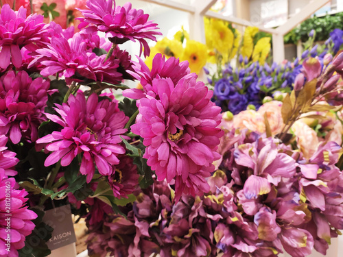 Colorful artificial flowers made of plastic display in shops for sale. 
