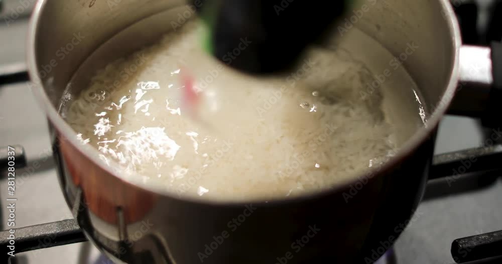 Water boils on the stove and boil rice there