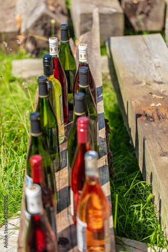 Fototapeta Naklejka Na Ścianę i Meble -  Wine Bottles sitting on railroad tie in park