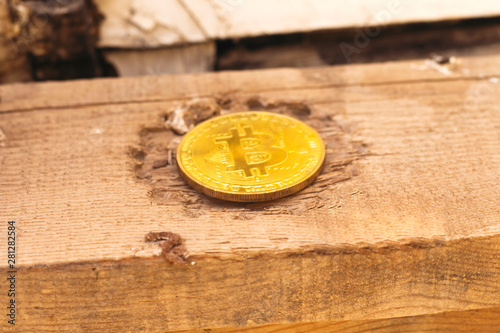 golden bitcoin above grunge wooden cube