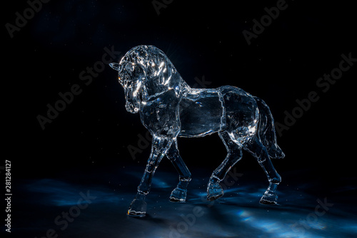 Crystal horse on a dark blue background among the star dust