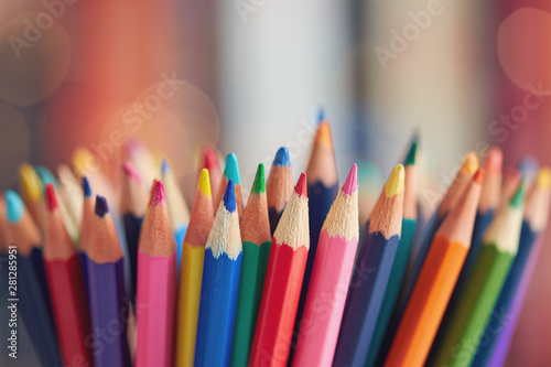 Colorful colored pencils on blurred bokeh background photo