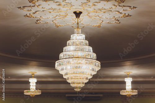 Close-up of a beautiful crystal chandelier Beautiful chandelier. luxury expensive chandelier hanging under ceiling. photo