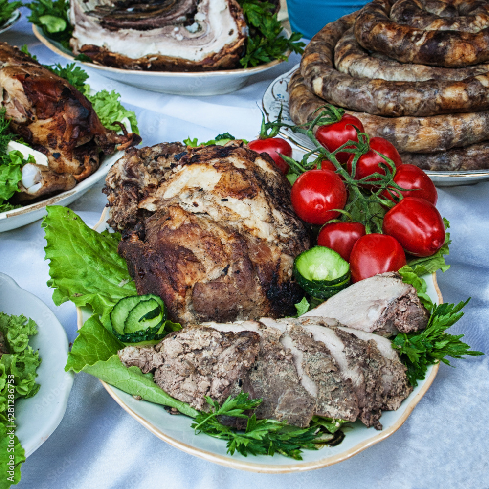 Meat products on the table with greens and vegetables Meat products on the table with greens and vegetables