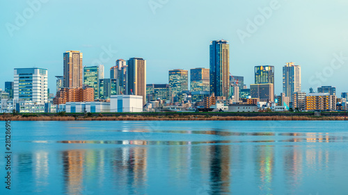 beautiful sunset landscape of Osaka city with modern buildings and river, Japan, panorama