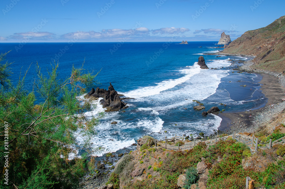 Naklejka premium Playa Benijo, wild nudist beach with big waves and black volcanic sand, located on the north of Tenerife near the Roques de Anaga.