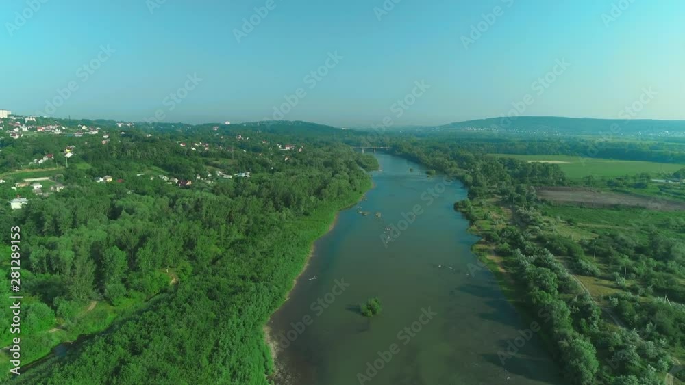 Drone shoot of the bridge over the river in a cottage village in the forest. 4K. Drone shoot of the bridge over the river in a cottage village in the forest. 4K.