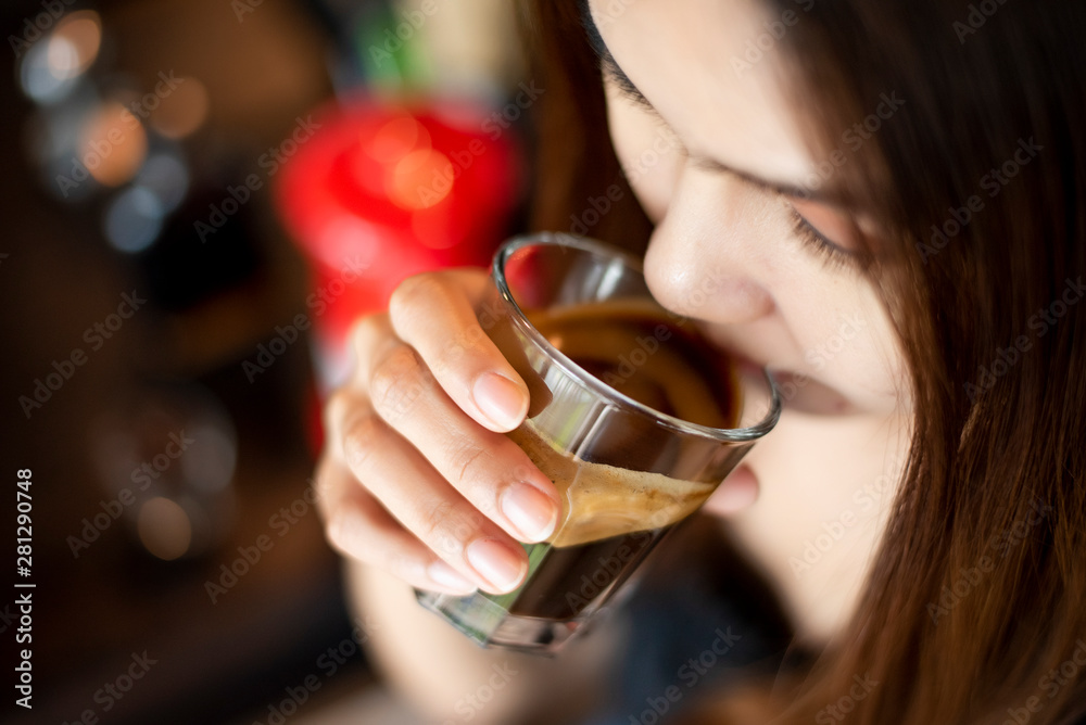 Beautiful asian woman is drinking coffee