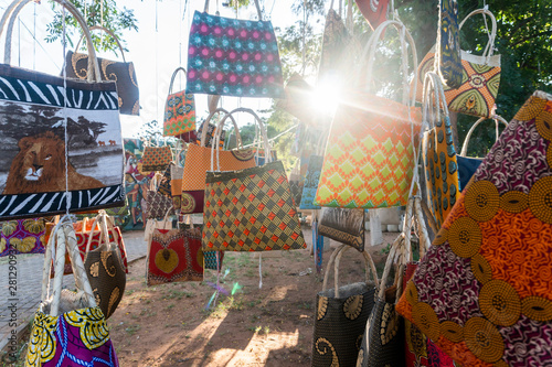 Traditional african market selling colorful  bags hanged on trees, Maputo, Mozambique photo