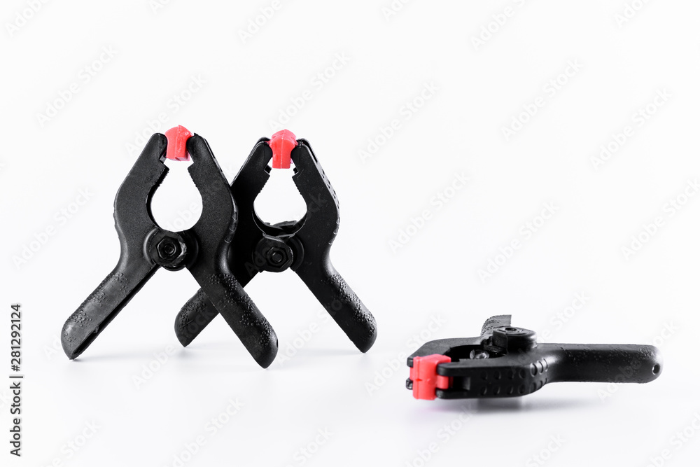 three Black plastic clamp on the white background. three Black plastic clamp on the white background.