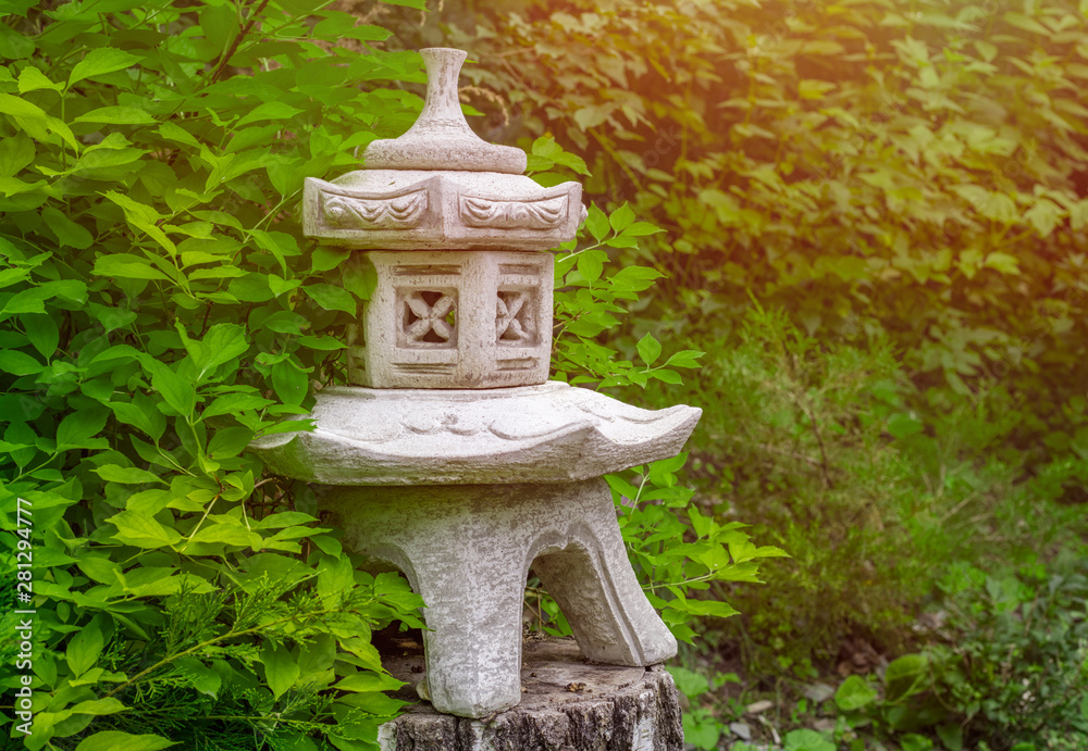 Decorative plaster figure on a birch stump in a green garden in summer. Copy space Decorative plaster figure on a birch stump in a green garden in summer. Copy space