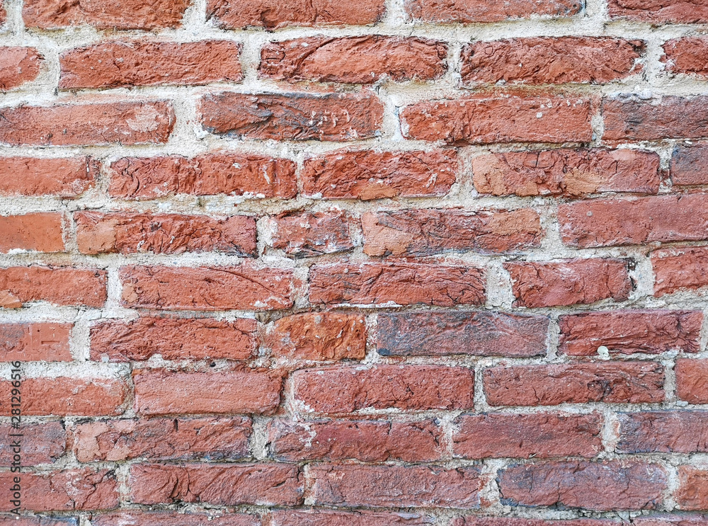 Fragment of an old historic red brick wall as a background or texture Fragment of an old historic red brick wall as a background or texture