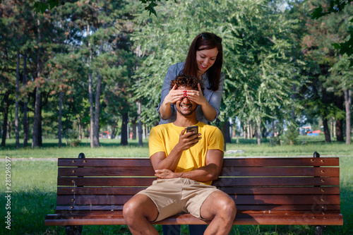 Guess who gesture-interracial couple in the park