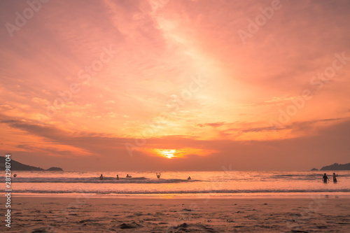 Sunset lovers, bright orange sky, on the beach Famous Phuket Patong Thailand