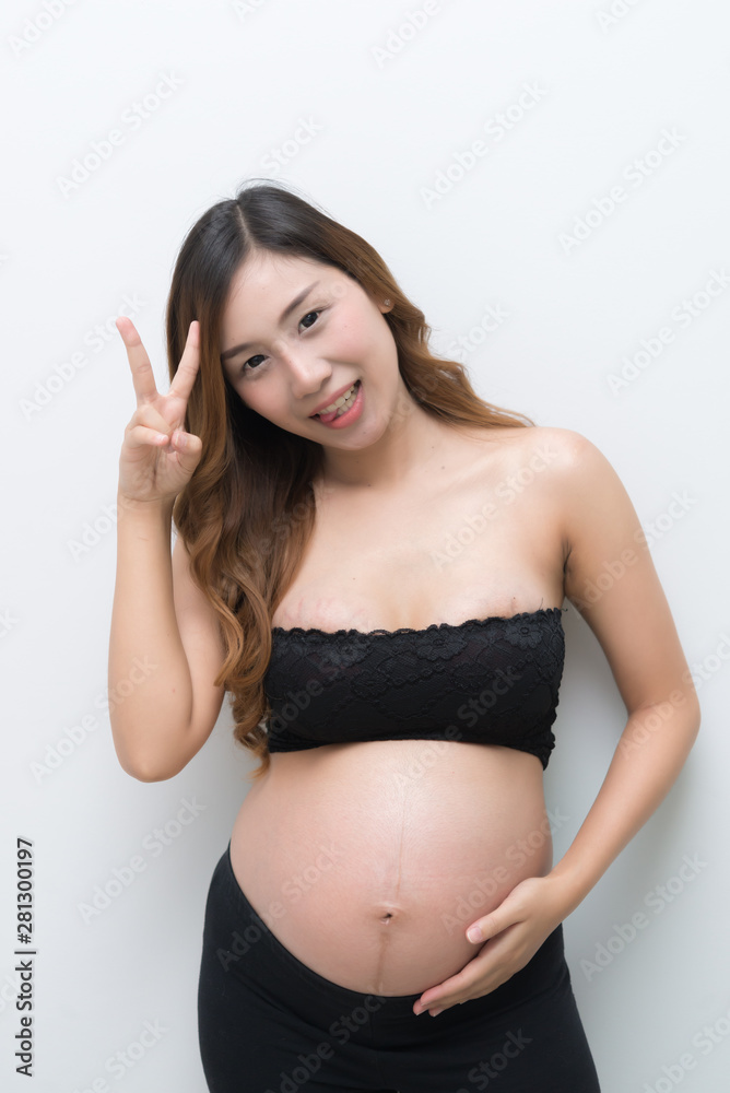 pregnant woman in white dress touch on her belly on white background,asian woman pregnant woman in white dress touch on her belly on white background,asian woman