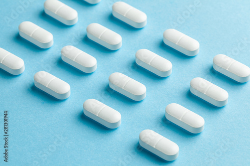 White pills on blue background.