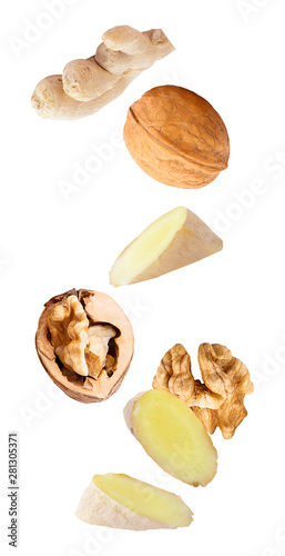 floating walnuts and ginger isolated on white background
