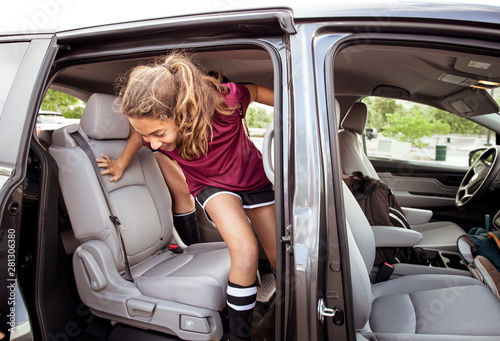 Fotografía Girl in soccer uniform disembarking from car