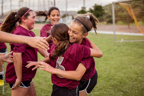 Players celebrating success after soccer match in field