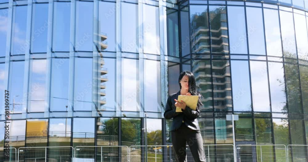 Happiness businesswoman calling by phone on the business architecture background. Concept of: Skyscraper, Business girl, Architect, Lifestyle. Happiness businesswoman calling by phone on the business architecture background. Concept of: Skyscraper, Business girl, Architect, Lifestyle.