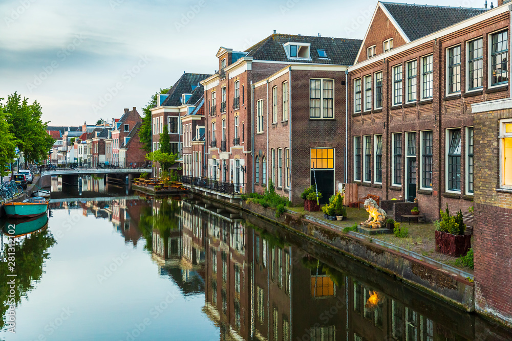 Traditional Dutch culture houses and canal during dusk in Leiden, Holland
