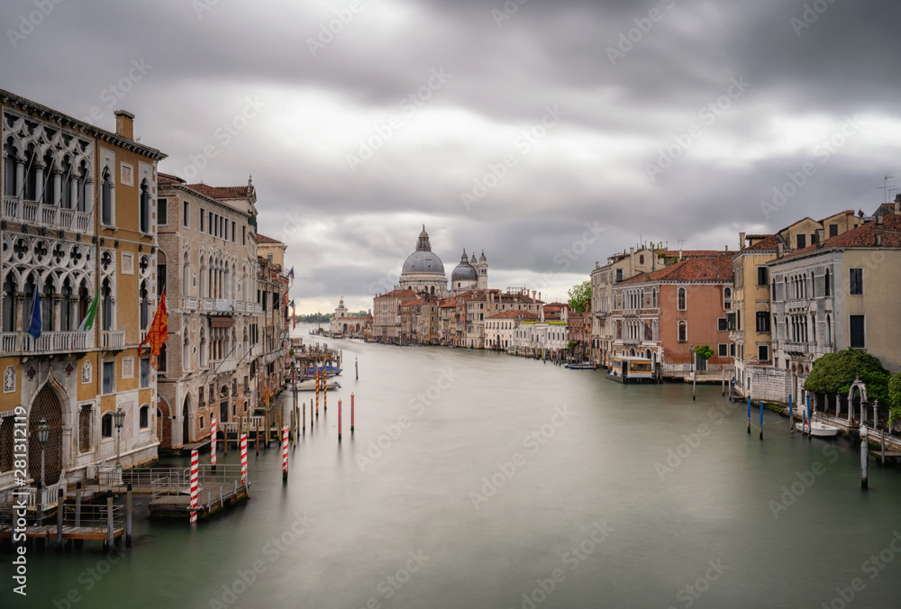 Grand Canal view in Venice, Italy. Long exposure photography of a cloudy sky. Can see the Basilica di Santa Maria della Salute