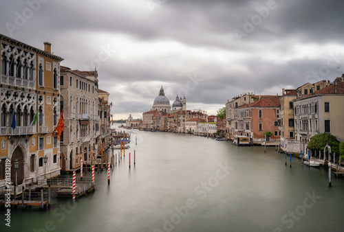 Grand Canal view in Venice, Italy. Long exposure photography of a cloudy sky. Can see the Basilica di Santa Maria della Salute