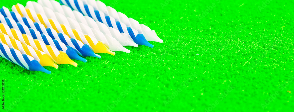 Fototapeta premium Small festive candles on a green background. Panorama