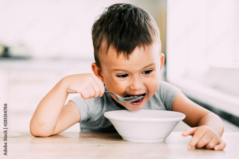 cute baby eating chocolate milk balls in the kitchen in the afternoon cute baby eating chocolate milk balls in the kitchen in the afternoon