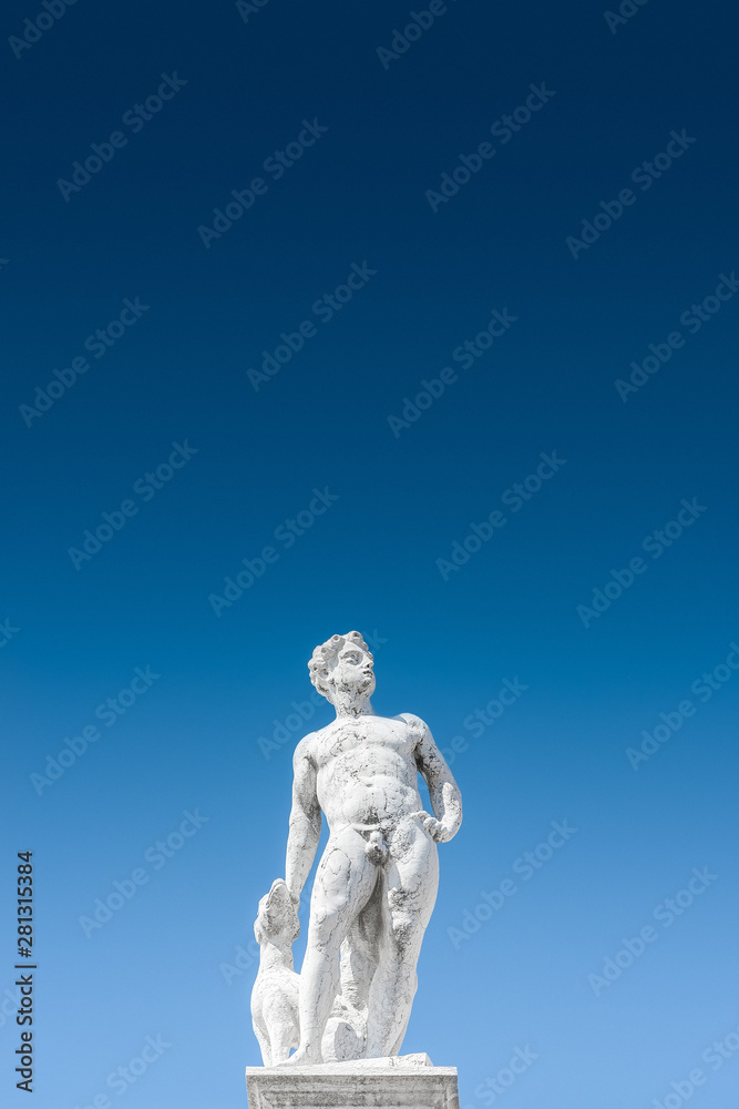 Statue as roof decoration of Doge's Palace in Venice, Italy